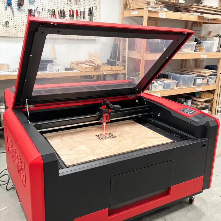 Enclosed CO2 laser engraver working on a wood panel